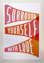 Load image into Gallery viewer, The text &quot;Surround yourself with love&quot; appears in expanding bands of color which transition from red to orange and back.
